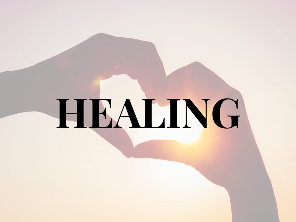 An image of hands making the shape of a heart and the words HEALING in large and bold print.