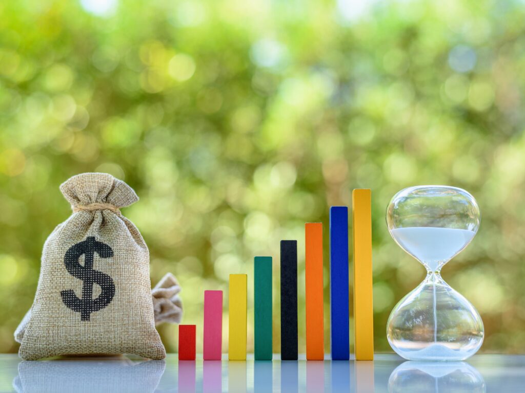 Image showing money, time horizon, and sand glass to reflect time