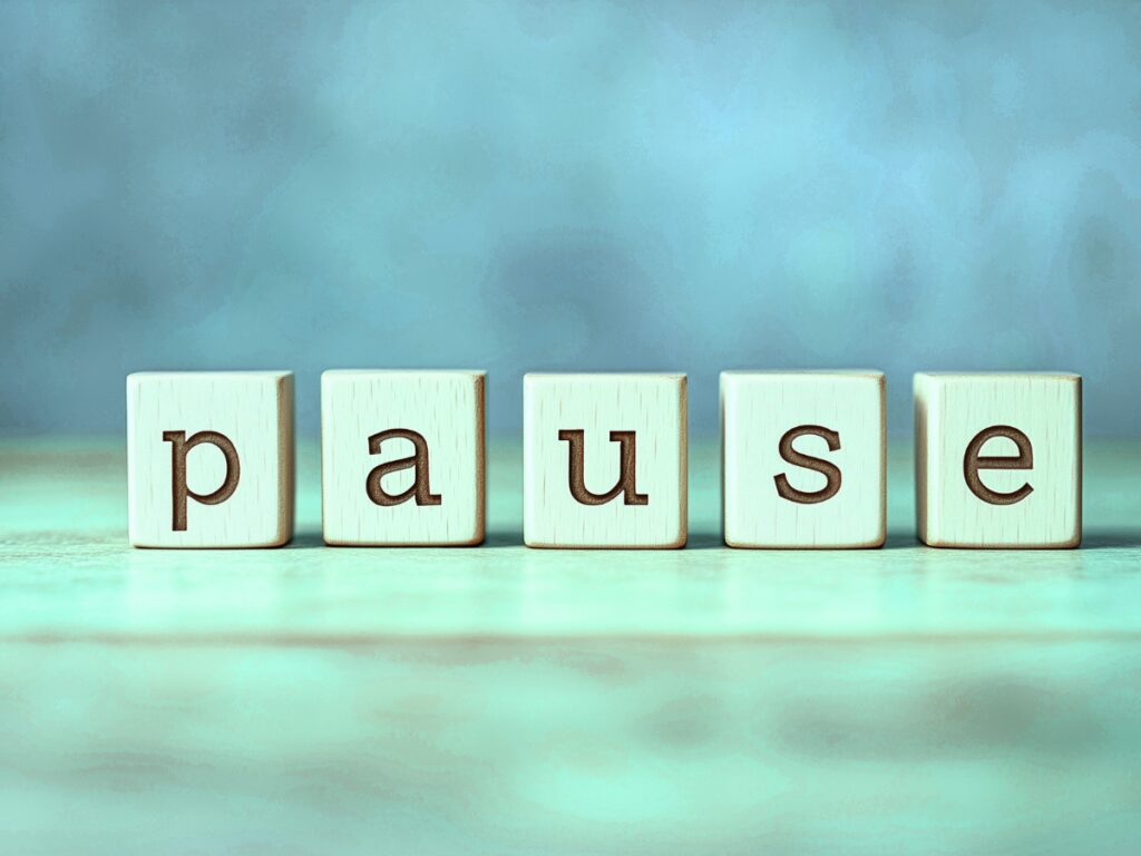 The word PAUSE spelled out in blue and green
